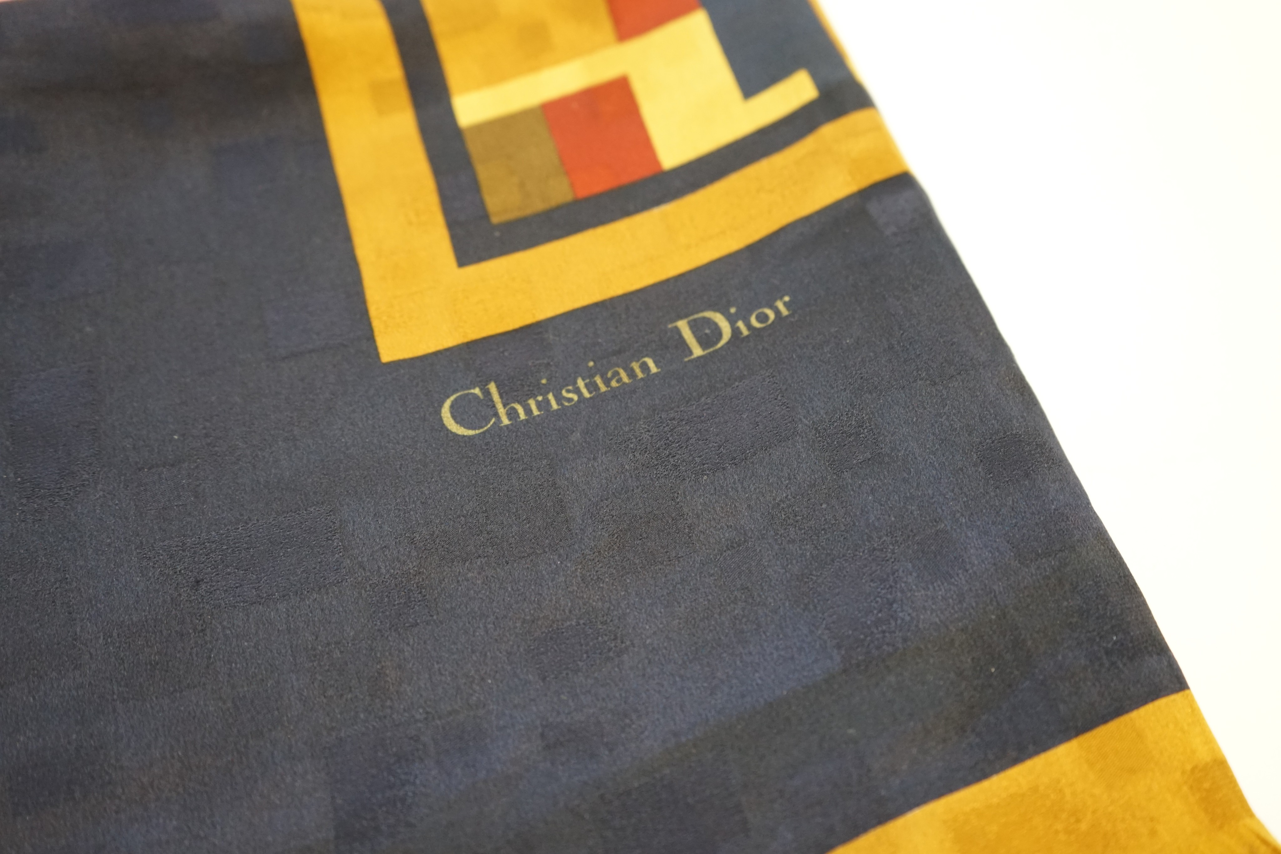 Four assorted scarves; Givenchy cotton, YSL peach chiffon, Christian Dior geometric and Loewe silk